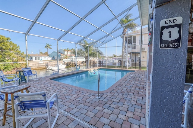 view of pool featuring a lanai and a patio