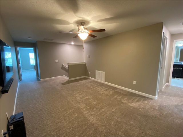 unfurnished room featuring ceiling fan and carpet floors