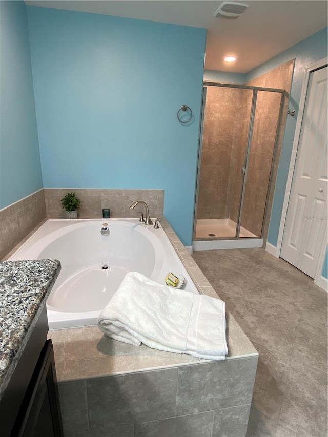 bathroom featuring vanity, tile patterned floors, and plus walk in shower