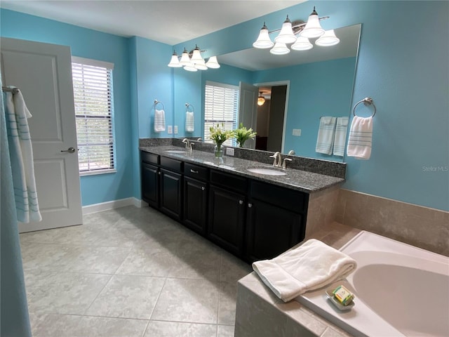 bathroom with vanity, a relaxing tiled tub, and tile patterned floors