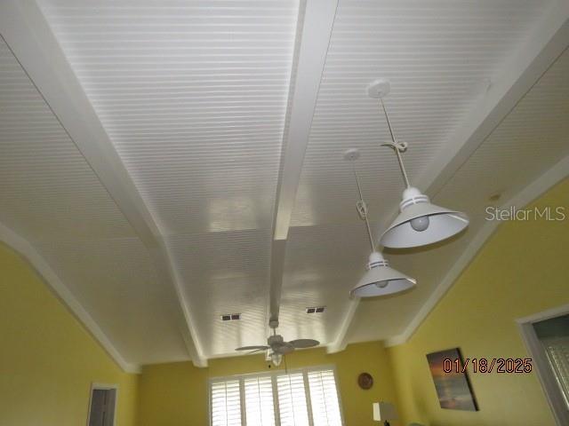 interior details with ceiling fan and beamed ceiling