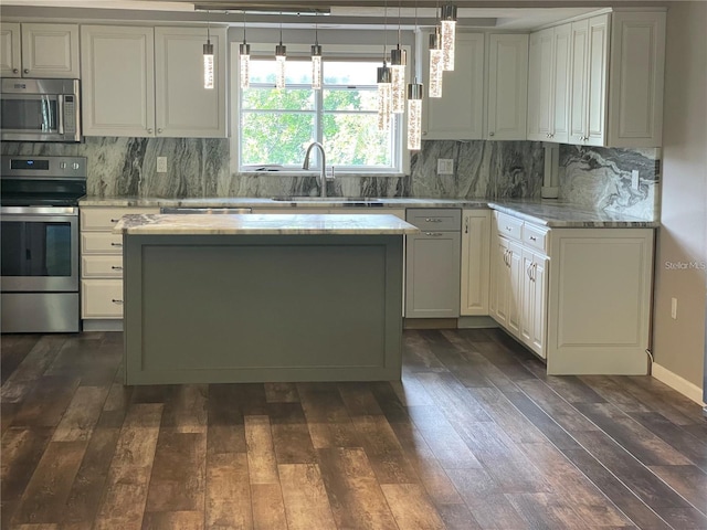 kitchen with stainless steel appliances, sink, light stone counters, dark hardwood / wood-style flooring, and pendant lighting