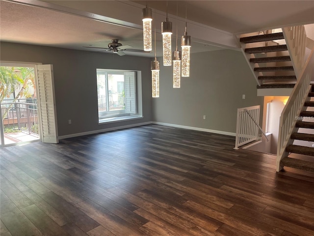 unfurnished living room with ceiling fan and dark hardwood / wood-style floors