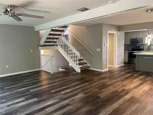 unfurnished living room with ceiling fan and dark hardwood / wood-style floors