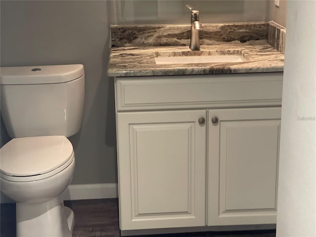 bathroom featuring vanity and toilet