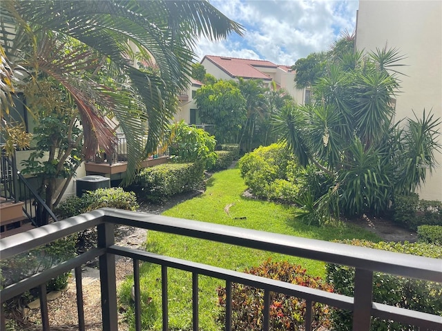 view of yard with a balcony and cooling unit