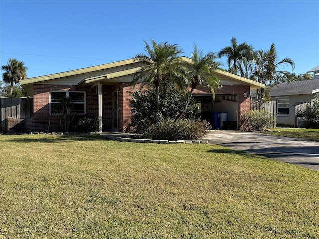 ranch-style home featuring a front yard and a carport