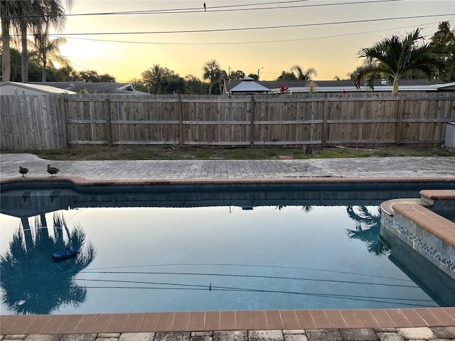 view of pool at dusk