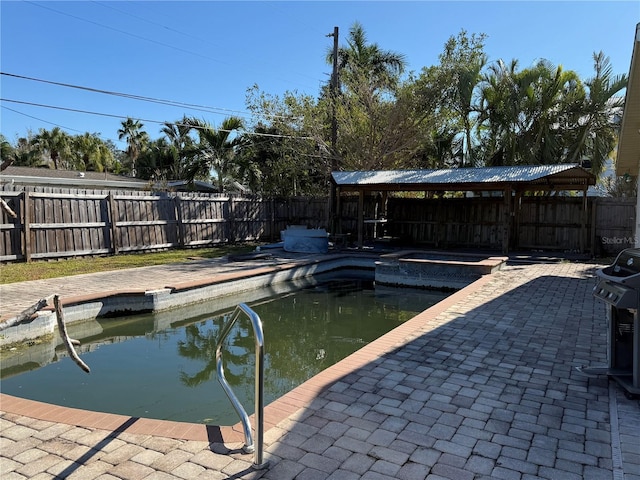 view of swimming pool featuring an in ground hot tub, a gazebo, and a patio area