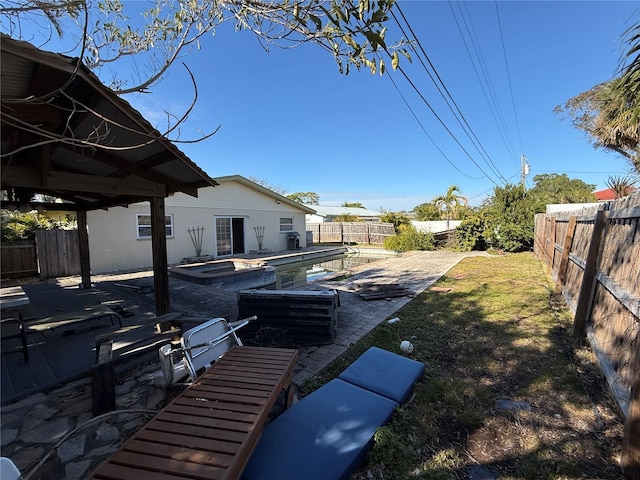 view of yard featuring a fenced in pool and a patio