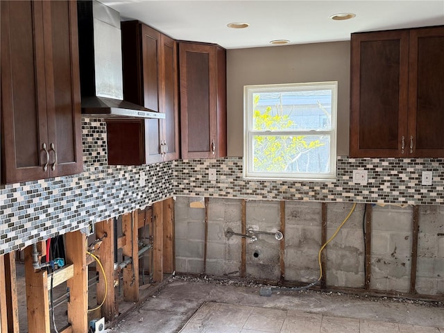 kitchen featuring wall chimney range hood