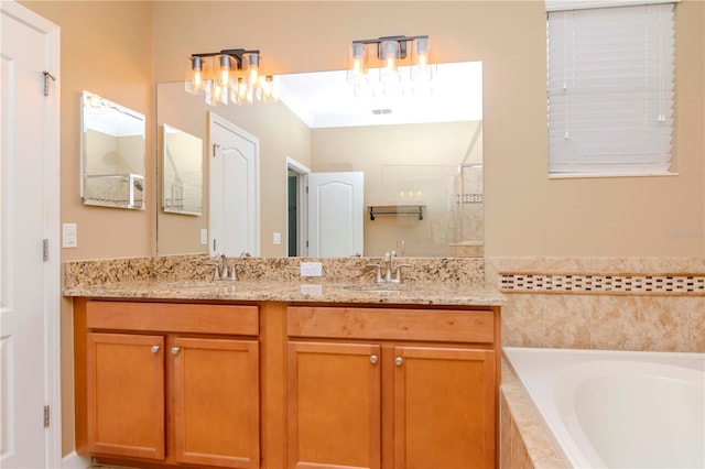 bathroom featuring vanity and shower with separate bathtub