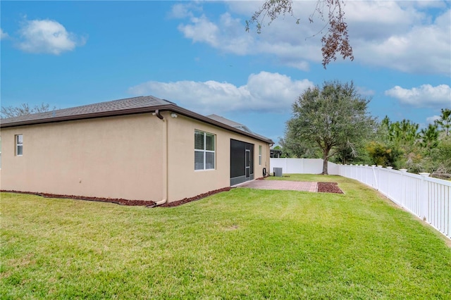 exterior space featuring central AC, a lawn, and a patio