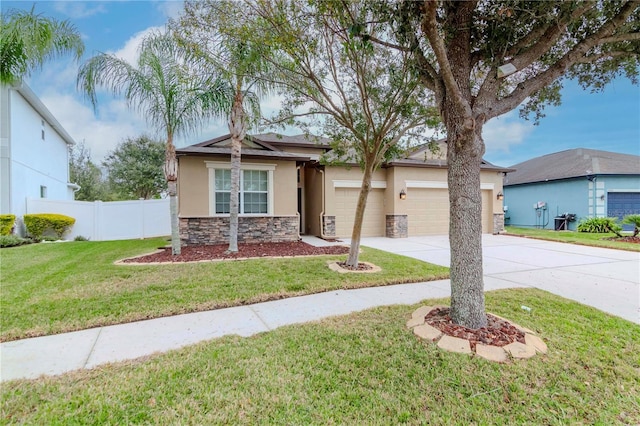 view of front of home with a front lawn and a garage