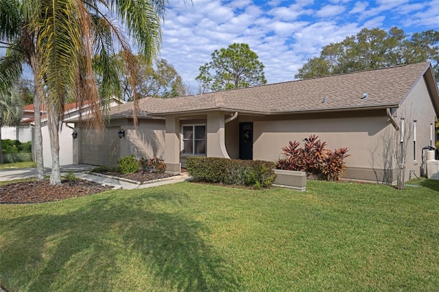 view of front facade featuring a front yard and a garage