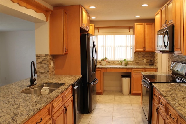 kitchen featuring light stone countertops, decorative backsplash, sink, black appliances, and light tile patterned flooring