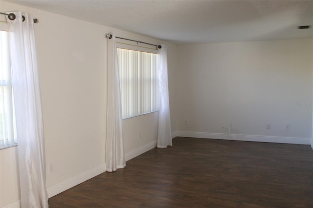 empty room featuring dark hardwood / wood-style flooring