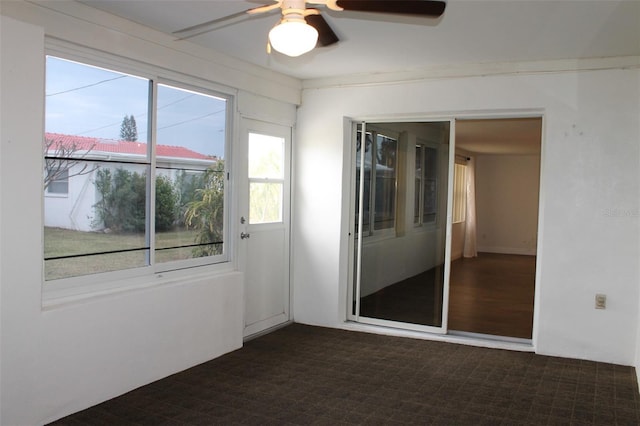 unfurnished room with ceiling fan and crown molding