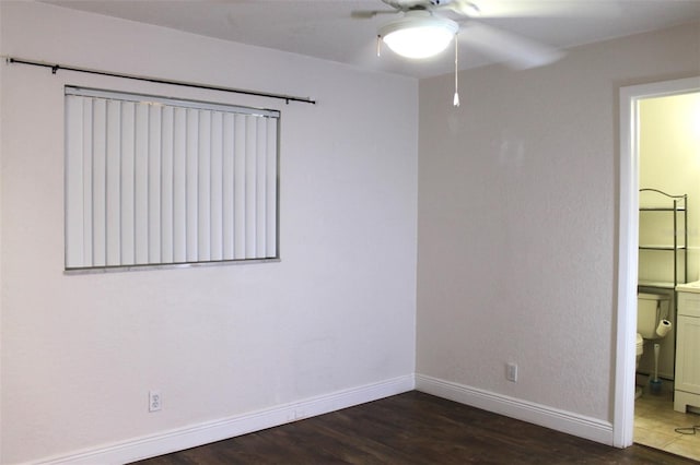 spare room with ceiling fan and dark hardwood / wood-style floors