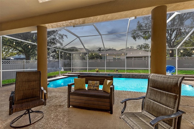 view of pool featuring a patio area and glass enclosure