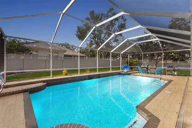 view of swimming pool featuring glass enclosure and a patio area