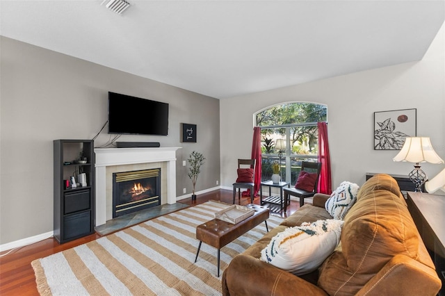 living room with a fireplace and dark hardwood / wood-style floors