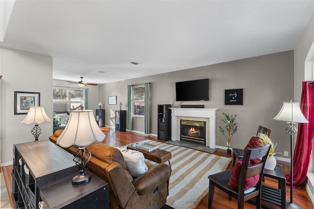 living room featuring ceiling fan and hardwood / wood-style floors