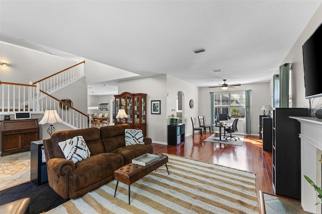 living room featuring ceiling fan and light hardwood / wood-style flooring