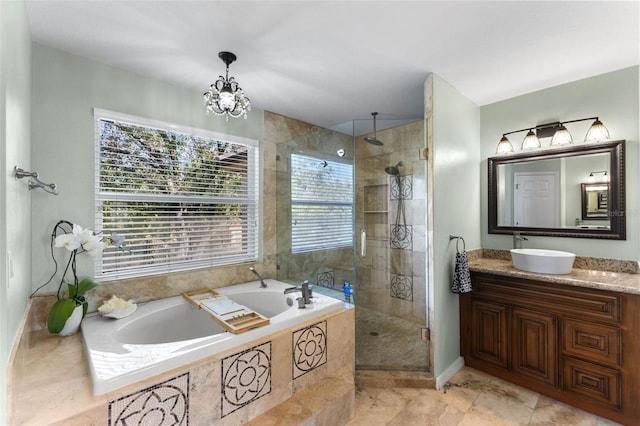 bathroom featuring a notable chandelier, plus walk in shower, and vanity