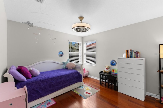 bedroom featuring dark hardwood / wood-style flooring