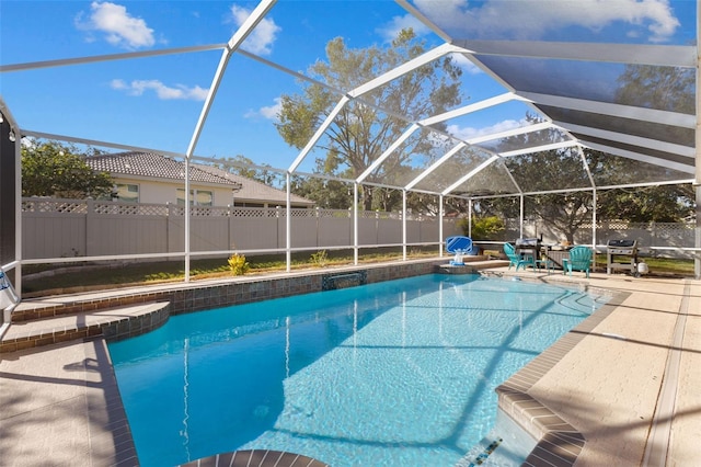 view of swimming pool featuring a lanai and a patio