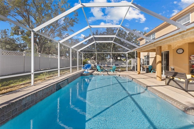 view of pool featuring a patio and glass enclosure