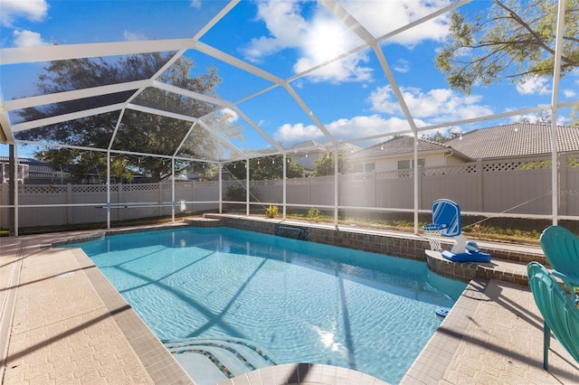 view of pool featuring a patio area and glass enclosure