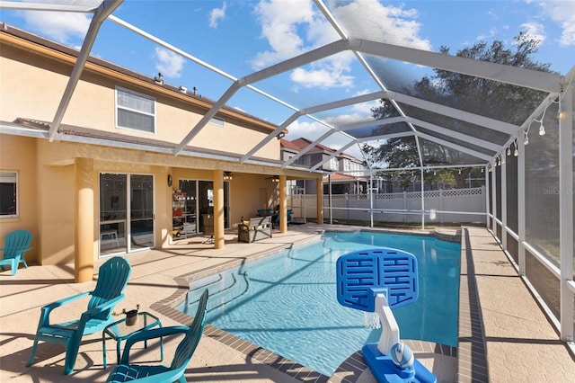 view of swimming pool with a patio area and glass enclosure