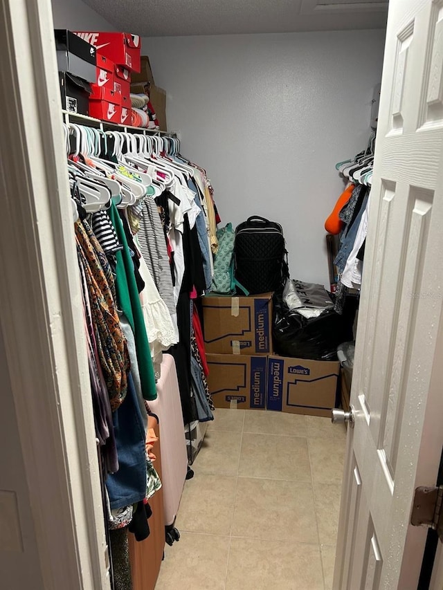 walk in closet featuring light tile patterned flooring