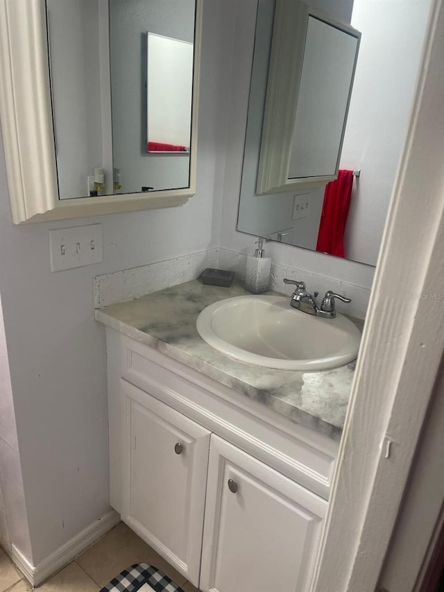 bathroom featuring tile patterned flooring and vanity