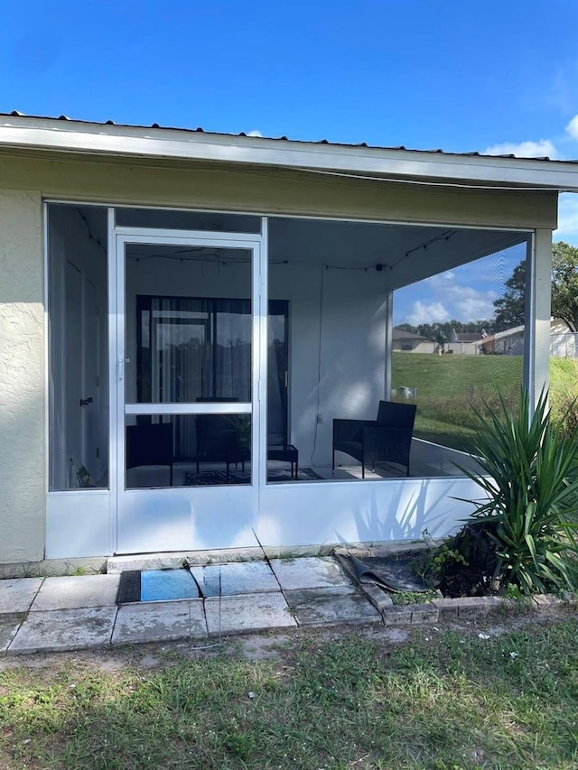 rear view of house with a sunroom