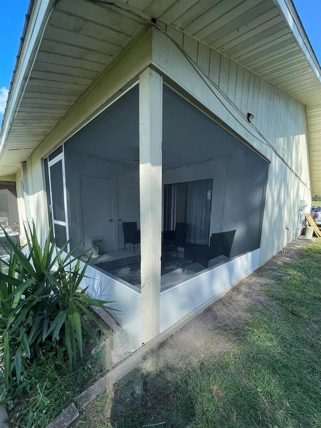 view of side of home featuring a sunroom