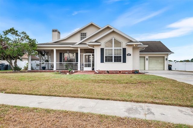 view of front of home with a porch, concrete driveway, an attached garage, a front yard, and a chimney