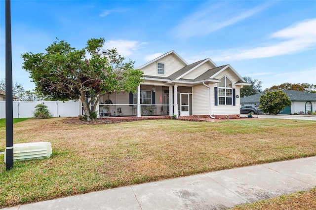 view of front of property with a front lawn and fence