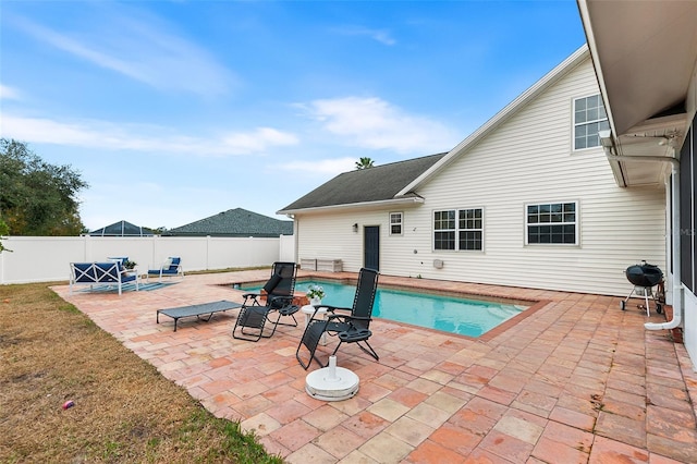 view of swimming pool featuring a patio, area for grilling, a fenced backyard, and a fenced in pool