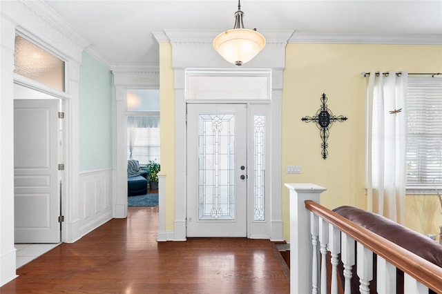 entryway featuring crown molding, wood finished floors, and a wealth of natural light