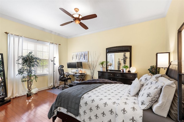 bedroom with crown molding, wood finished floors, baseboards, and ceiling fan