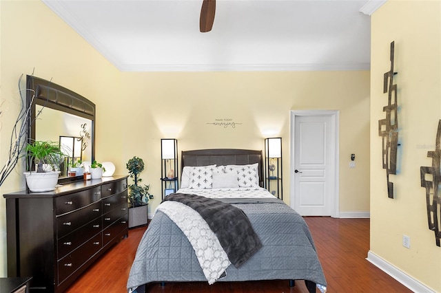 bedroom featuring dark wood-style floors, a ceiling fan, baseboards, and ornamental molding