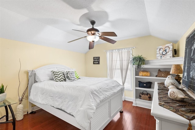 bedroom with a ceiling fan, vaulted ceiling, baseboards, and dark wood-style flooring