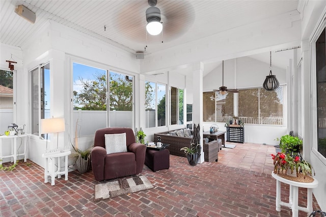 sunroom featuring lofted ceiling and ceiling fan