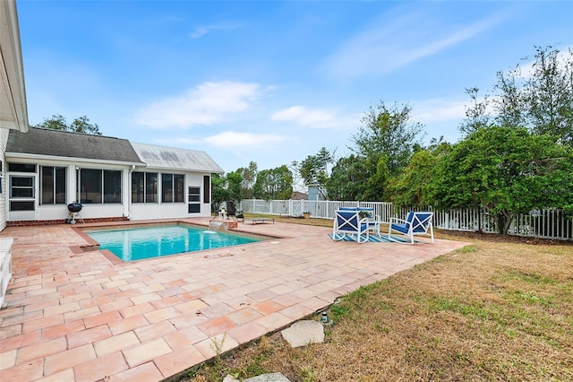 view of swimming pool with a fenced in pool, a patio, a fenced backyard, and a sunroom