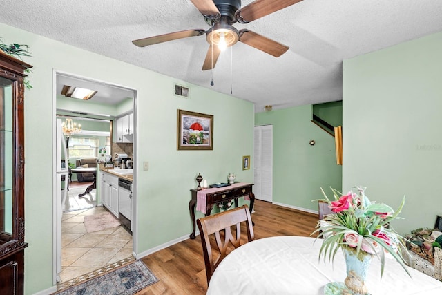 dining area featuring ceiling fan, a textured ceiling, and light hardwood / wood-style floors