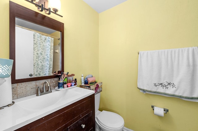 bathroom featuring walk in shower, vanity, and toilet