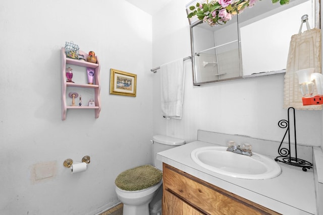 bathroom with vanity, walk in shower, and toilet